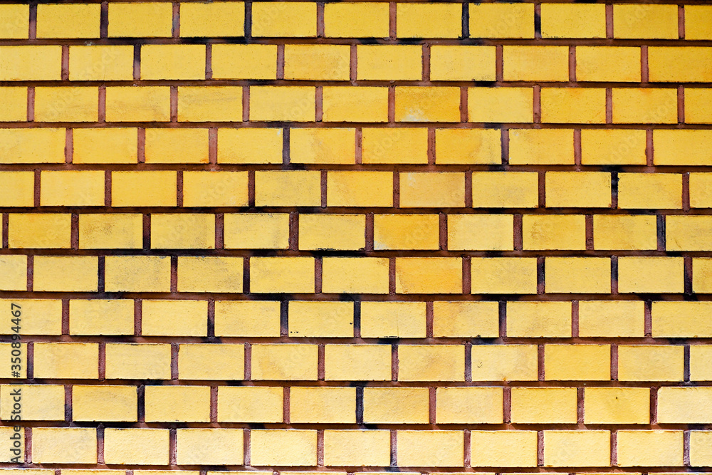 Obraz premium symmetrical orange brick wall. the exterior of the house. texture of rectangular bricks