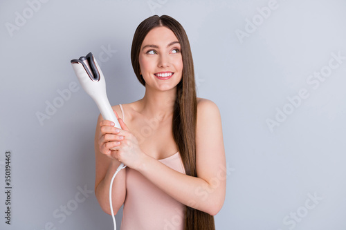 Obraz na plátně Photo of beautiful model lady long hairstyle hold electric styler curler making