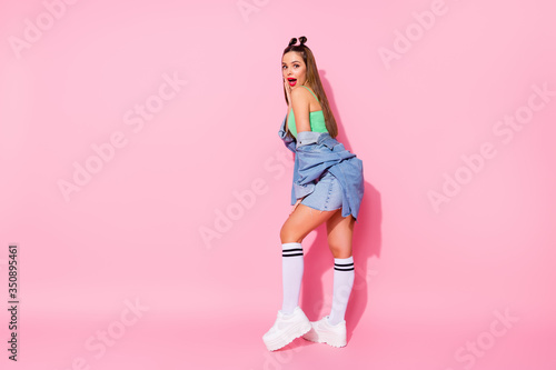 Full length body size view of nice-looking attractive lovely casual trendy glamorous slim fit slender funny amazed cheerful girlfriend having fun posing isolated over pink pastel color background