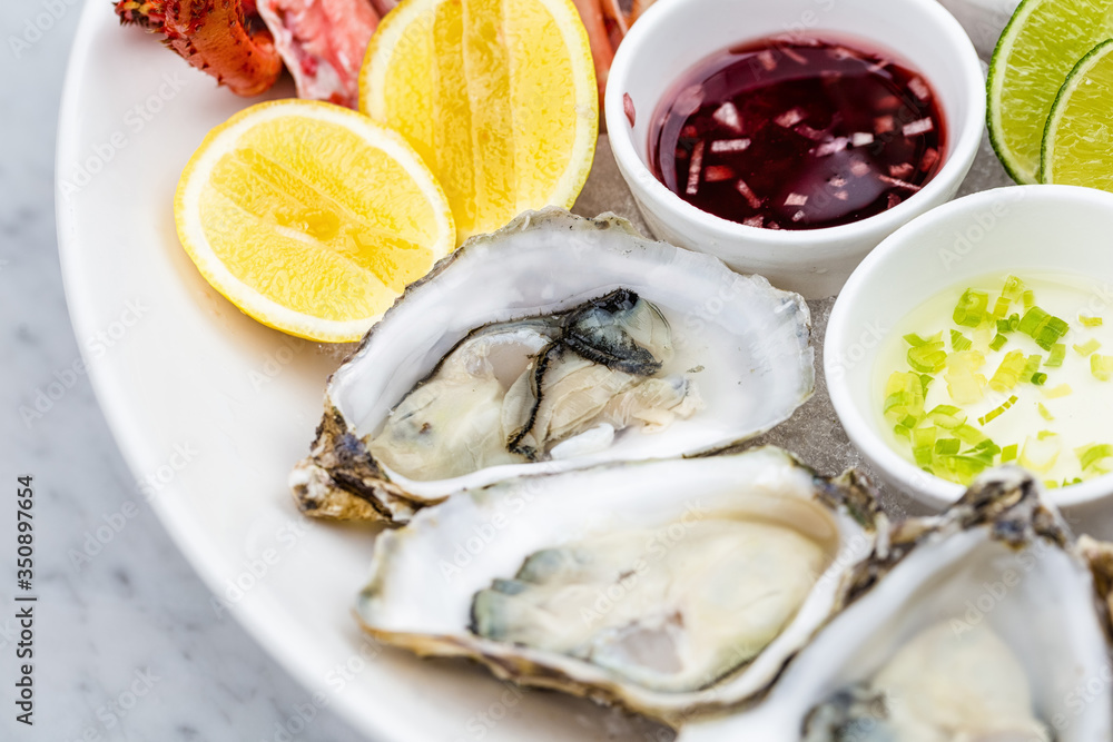 Fresh oysters served on the plate with ice
