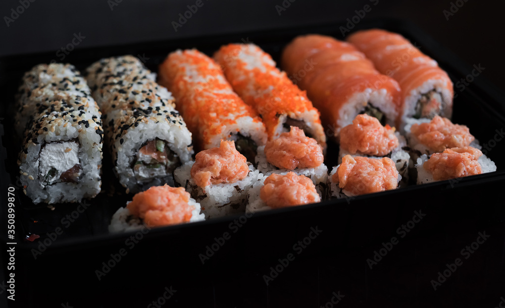 Pickled ginger and rol california. A big set of Japanese rolls with fish. Delivery of ready food. Advertizing of food Pickled ginger and rol california. A big set of Japanese rolls with fish. Delivery of ready food. Advertizing of food
