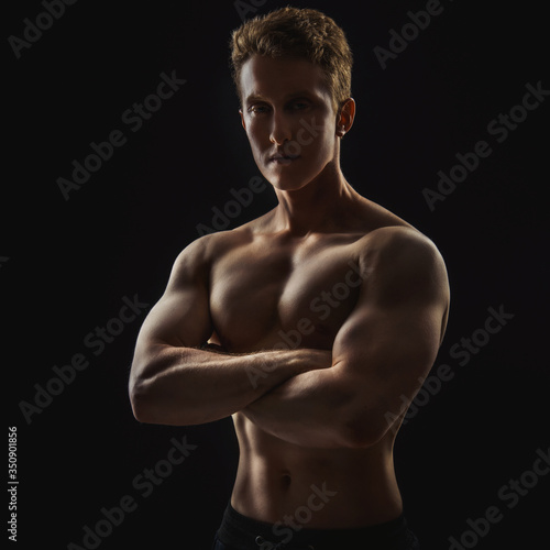 Young strong sweaty focused fit muscular man with big muscles