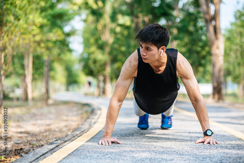 Men wear black shirts with muscles push up on the street. © Johnstocker