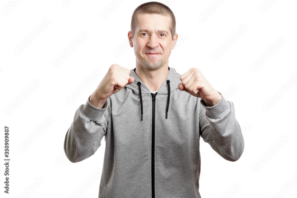smiling joyful man, wearing a sports hooded sweatshirt, holds cams with joy. Isolated smiling joyful man, wearing a sports hooded sweatshirt, holds cams with joy. Isolated