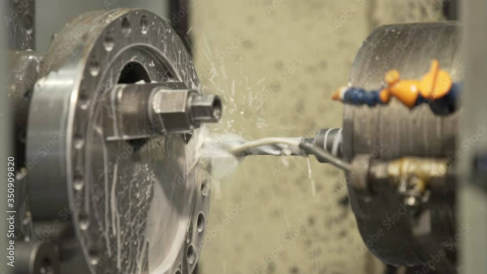 Produces metal detail in factory. Machine tools for metal working. A metal workpiece is machined by an electric machine. Cutting metal modern processing technology. Coolant and lubrication. Produces metal detail in factory. Machine tools for metal working. A metal workpiece is machined by an electric machine. Cutting metal modern processing technology. Coolant and lubrication.
