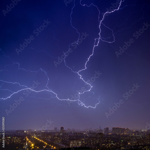 Lightning strikes in the night sky over the night town 2