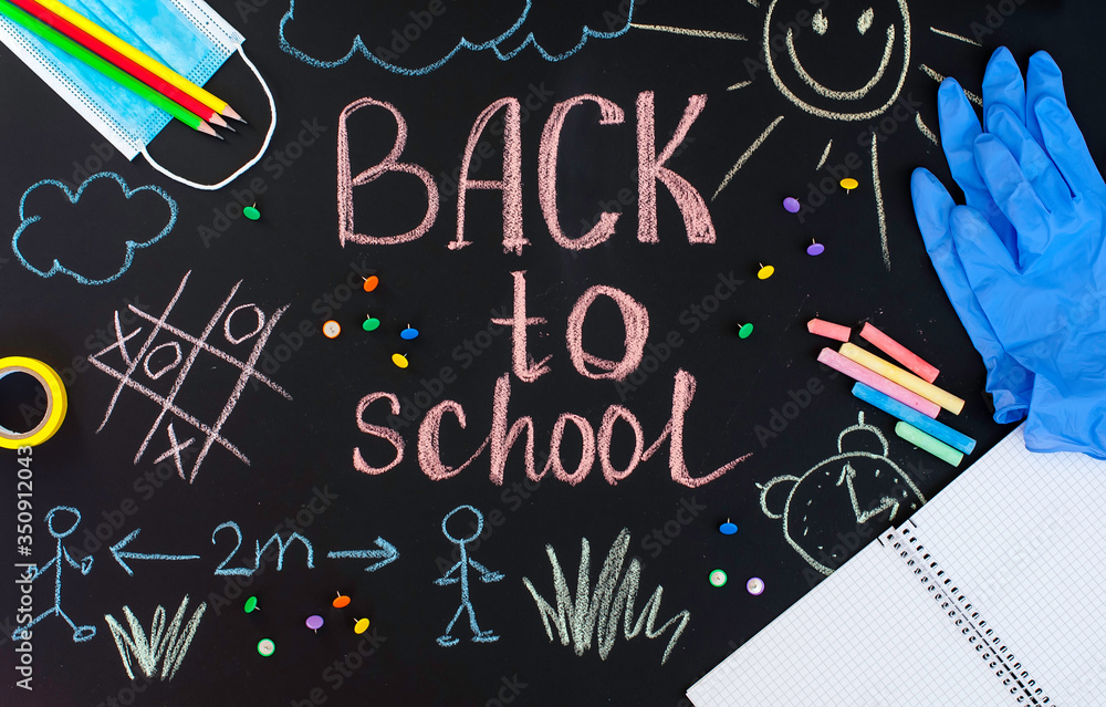 Back to school background written by crayons on the blackboard also with face mask and latex gloves to protect from coronavirus. Back to school background written by crayons on the blackboard also with face mask and latex gloves to protect from coronavirus.