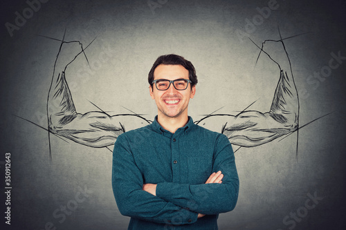 Brave and confident guy keeps arms folded, strong personality, has no fears. Business person wears eyeglasses, powerful hero muscular arms behind his back shows the inner strength. Big biceps sketch. photo