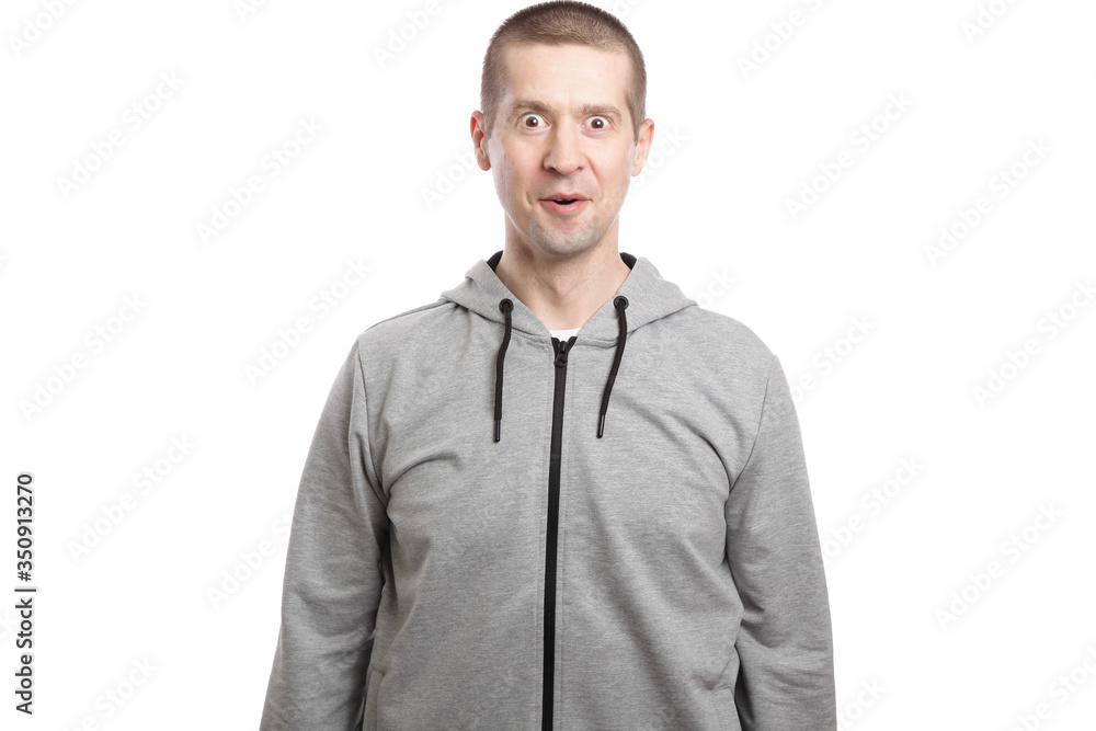 surprised man admires luck and victory, opened his mouth, dressed in a gray jacket. A look into the camera. Isolated surprised man admires luck and victory, opened his mouth, dressed in a gray jacket. A look into the camera. Isolated