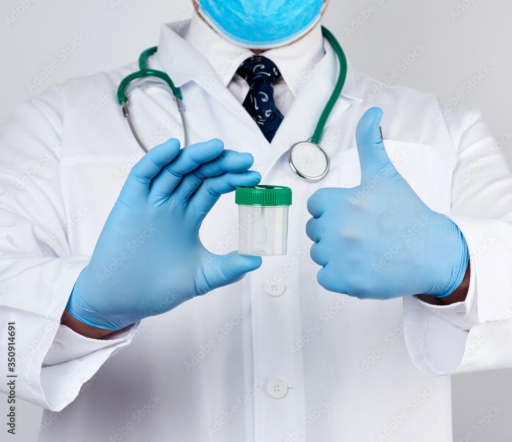 doctor in a white coat and blue sterile latex gloves holds a plastic jar for stool analysis doctor in a white coat and blue sterile latex gloves holds a plastic jar for stool analysis