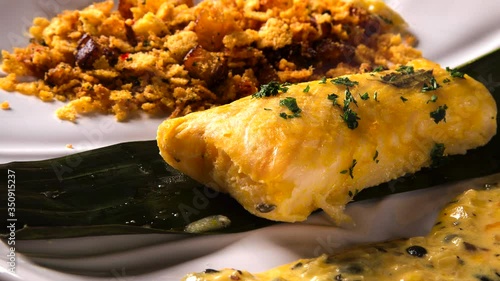 Fried fish with farofa and passion fruit sauce - Traditional amazonian dish - Filhote caboclo photo