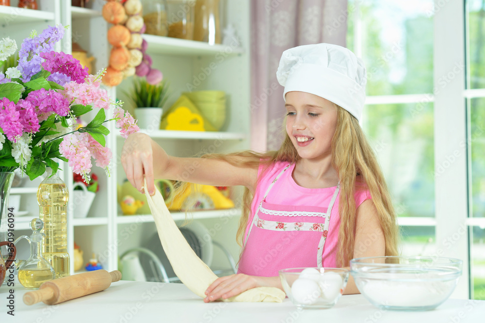 Beautiful girl baking and posing in the kitchen at home Beautiful girl baking and posing in the kitchen at home