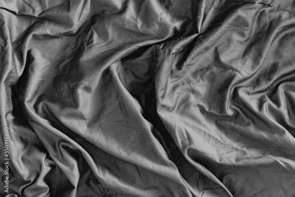 Grey fabric background with cloth wave folds, abstract waving textile. Grey fabric background with cloth wave folds, abstract waving textile.
