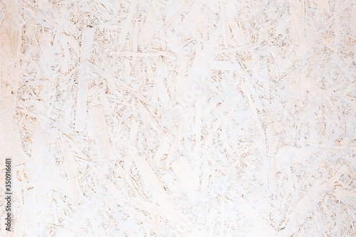 OSB panel texture. Oriented Strand Board. Chipboard building material. OSB wooden panel made of pressed sandy brown wood shavings as background © nata_zhekova