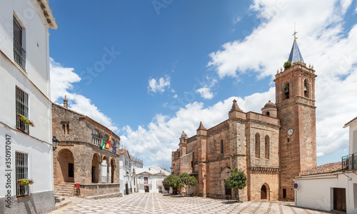 View of Church of the Immaculate Conception (Iglesia de la Inmaculada Concepcion) in the village of Zufre with a beautiful old style hanging lamp in the foreground, Huelva mountains, Spain. photo