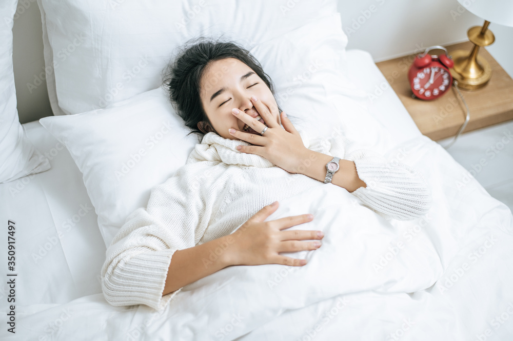 A woman wearing a white shirt to sleep. A woman wearing a white shirt to sleep.