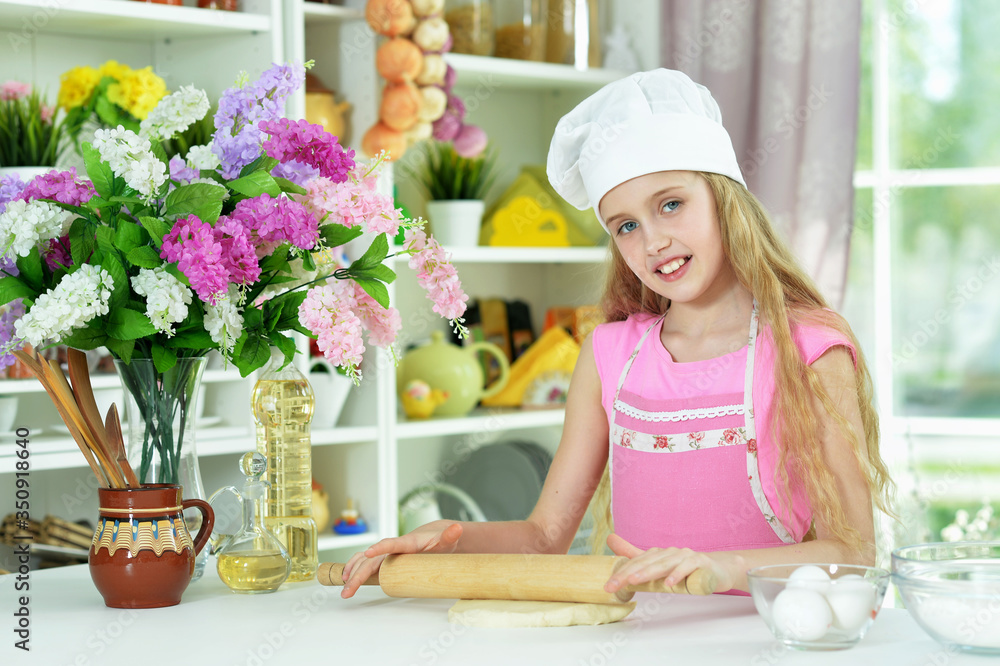 Beautiful girl baking and posing in the kitchen at home Beautiful girl baking and posing in the kitchen at home