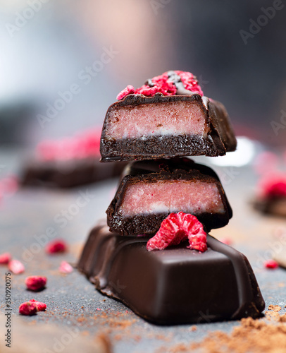 Chocolate crimson candies without sugar. Raw vegan chocolate candies. Lactose free candies. Gluten free candies. Without artificial dyes chocolate. photo