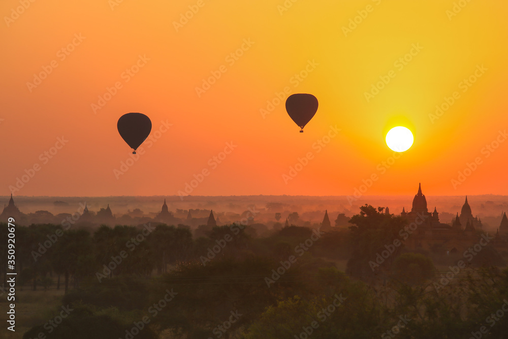 Silhouette of hot air balloon over Bagan at sunrise in misty morning, Myanmar Silhouette of hot air balloon over Bagan at sunrise in misty morning, Myanmar