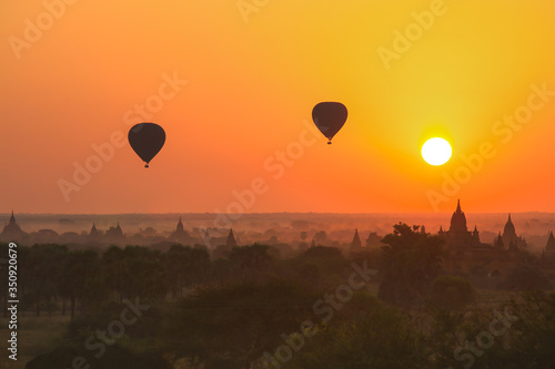 Silhouette of hot air balloon over Bagan at sunrise in misty morning, Myanmar
