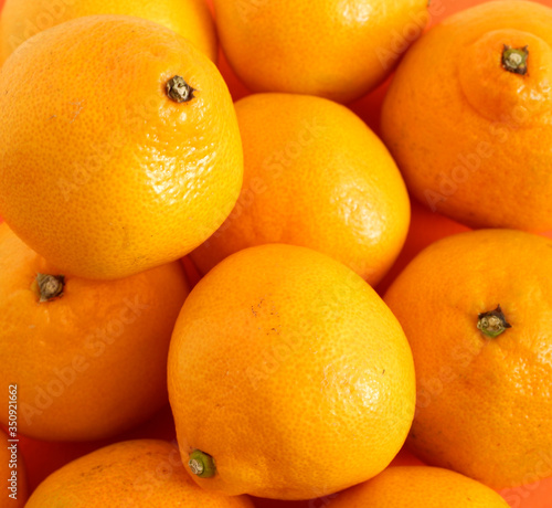 Background of juicy fruit oranges. The texture of the Mandarin. fruits. Backgrounds