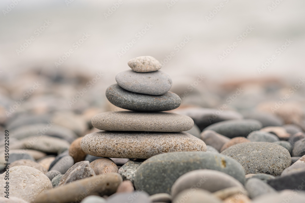 stones on the beach in the shape of a pyramid. balance and meditation, space for text stones on the beach in the shape of a pyramid. balance and meditation, space for text