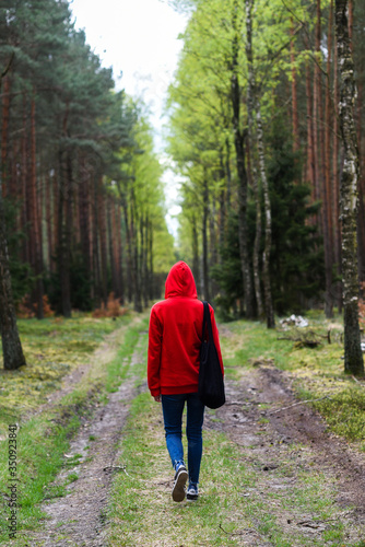 Wallpaper Mural A woman walking in the forest in a red hood. Torontodigital.ca