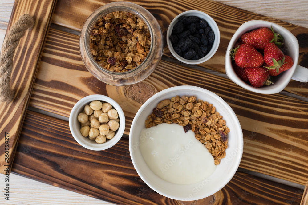 Plate with muesli, nuts and strawberries, healthy breakfast Plate with muesli, nuts and strawberries, healthy breakfast