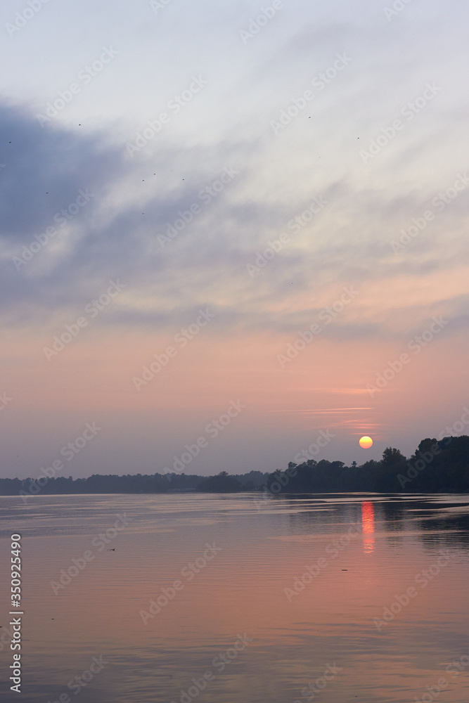 Naklejka premium Beautiful autumn sunset over river