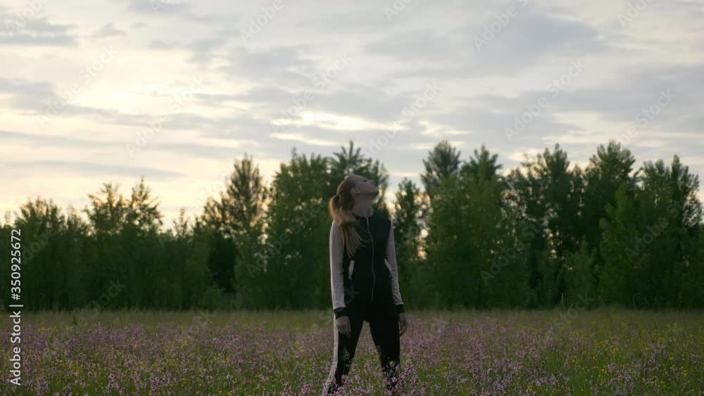 Woman Doing Exercise Warming up Workout Fitness in Grass Field. Countryside Rural Scenery. Rainy Clouds Weather Spring season. 2x Slow motion - 1/2 speed of 60 FPS. Woman Doing Exercise Warming up Workout Fitness in Grass Field. Countryside Rural Scenery. Rainy Clouds Weather Spring season. 2x Slow motion - 1/2 speed of 60 FPS.