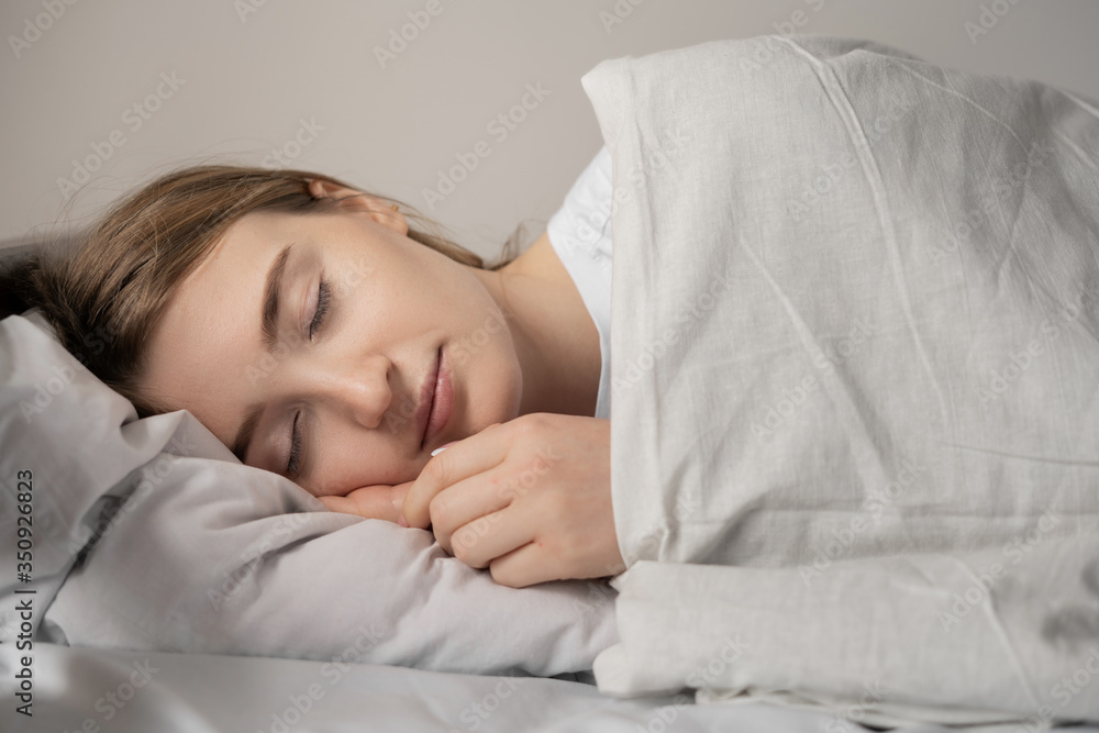 Obraz premium beautiful girl sleeps in the bedroom, good sleep excellent health.