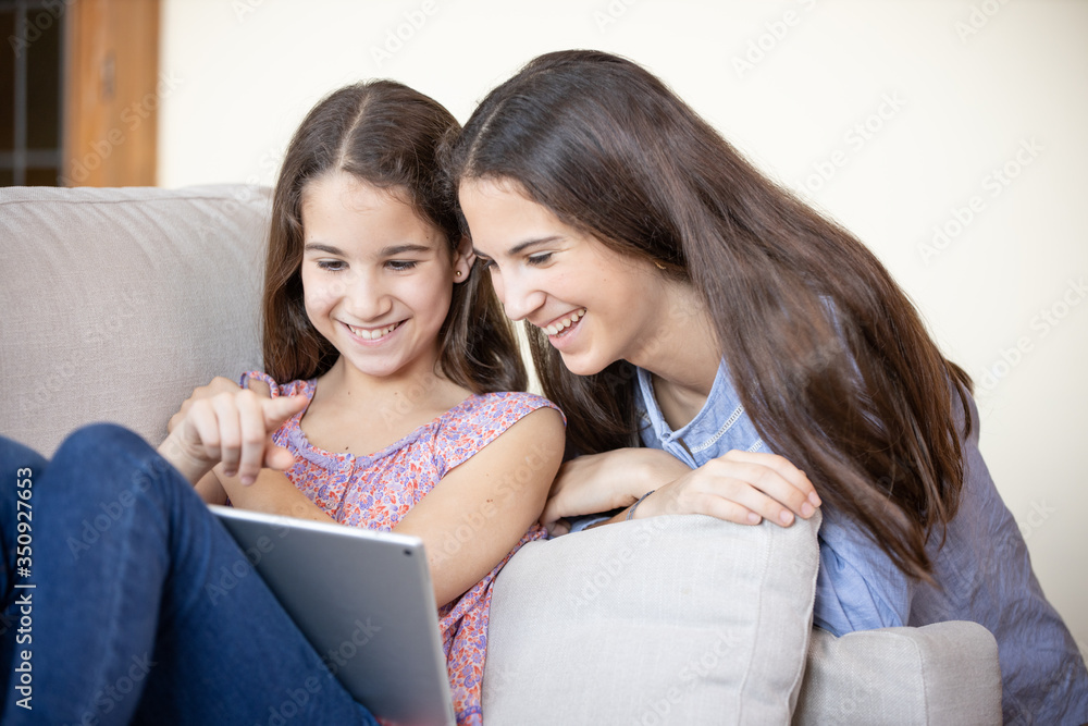 Two girls playing with a tablet Two girls playing with a tablet