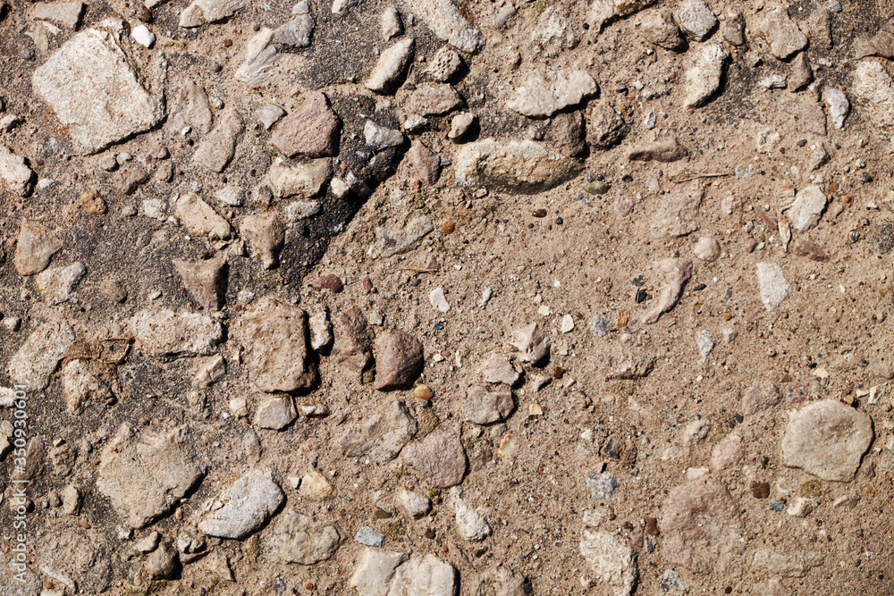 The texture of the broken road. Old building blocks. Background for screensaver monitor The texture of the broken road. Old building blocks. Background for screensaver monitor