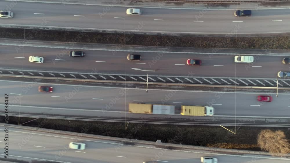 Aerial top down view of elevated highway traffic. Drone shot flying over junction, rush hour cars driving by. Urban transportation and air pollution background in 4K resolution Aerial top down view of elevated highway traffic. Drone shot flying over junction, rush hour cars driving by. Urban transportation and air pollution background in 4K resolution