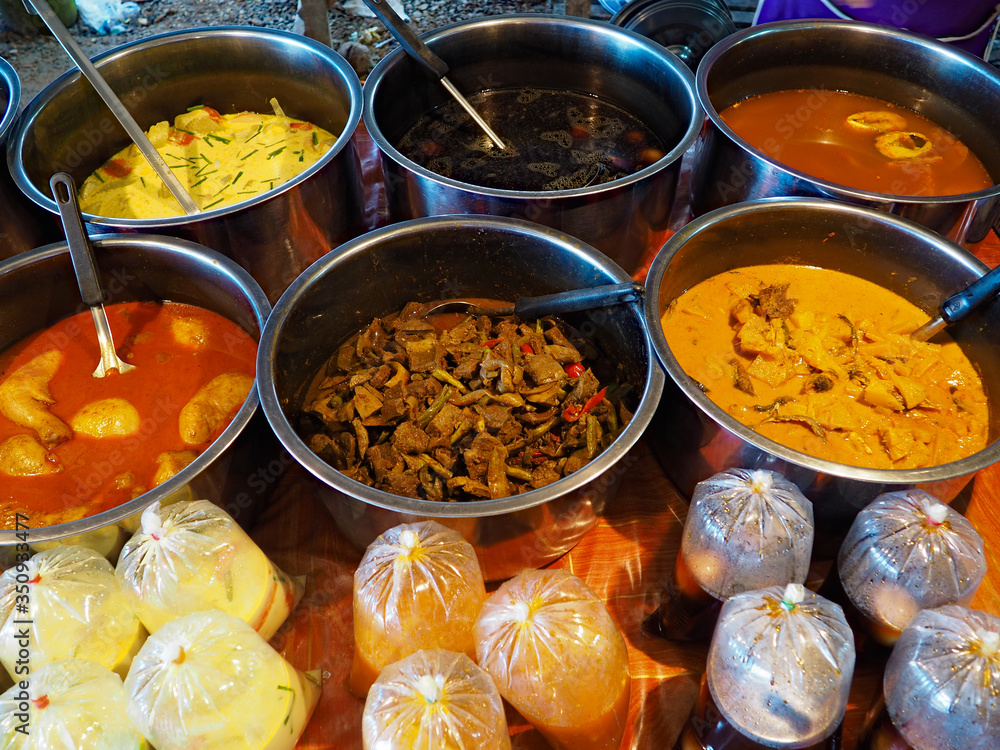 Selling Thai traditional food at a street market in Thailand Selling Thai traditional food at a street market in Thailand