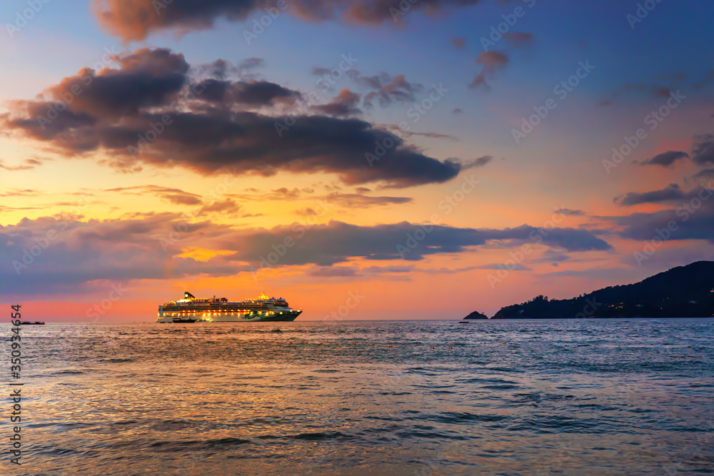 evening colorful sea sunset. the glowing ship dropped anchor not far from the shore.