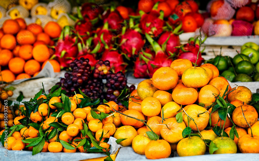 Asian farmer market selling fresh fruit in Vietnam reflex
