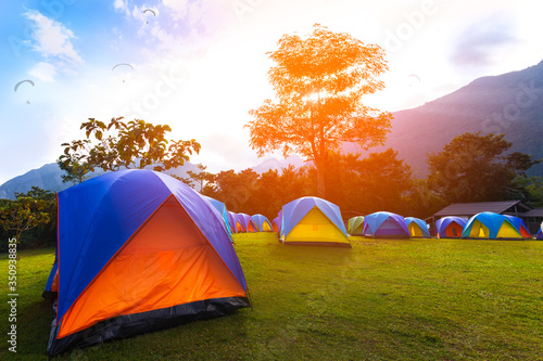 Fototapeta Naklejka Na Ścianę i Meble -  The Colorful Camping Tents  near mountain  in the morning