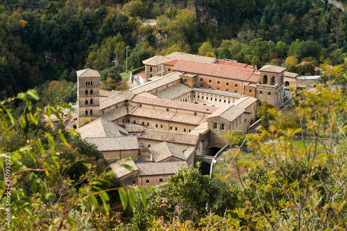 View of Saint Scholastica medieval monastery surrounded, by trees in Subiaco. Founded by Benedict of Nursia photo