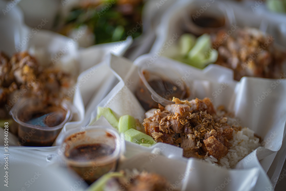 Crispy pork on rice in a box, ready to sell