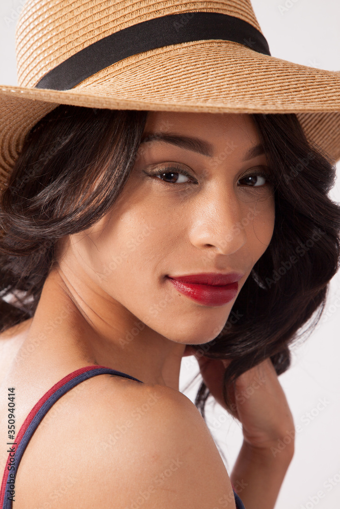 Lovely woman in a straw hat looking thoughtful Lovely woman in a straw hat looking thoughtful