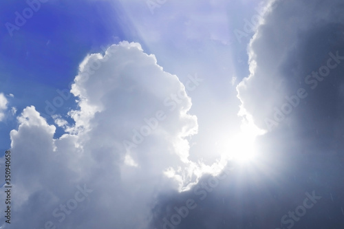 the sun's rays break through the bluish clouds. the concept of new hope or spiritual uplift