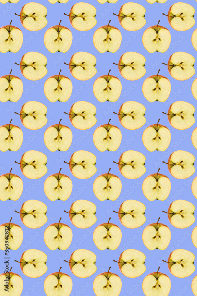 Seamless pattern of apples on a blue background. The texture of the food.