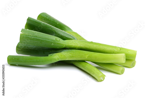 young green garlic leaves isolated on white background