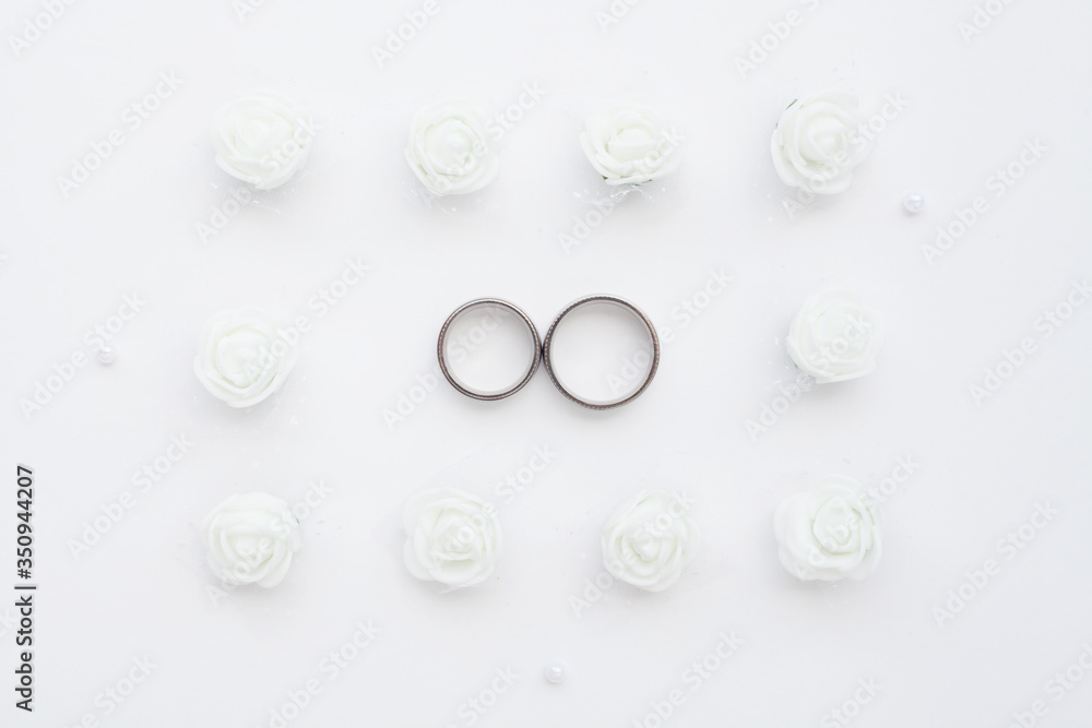Wedding rings close-up on a white background top view. The concept of wedding cards.