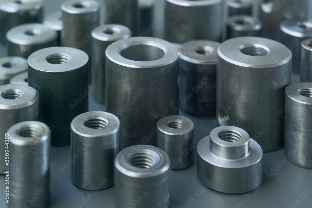 industrial background. cylindrical metal details on grey background industrial background. cylindrical metal details on grey background