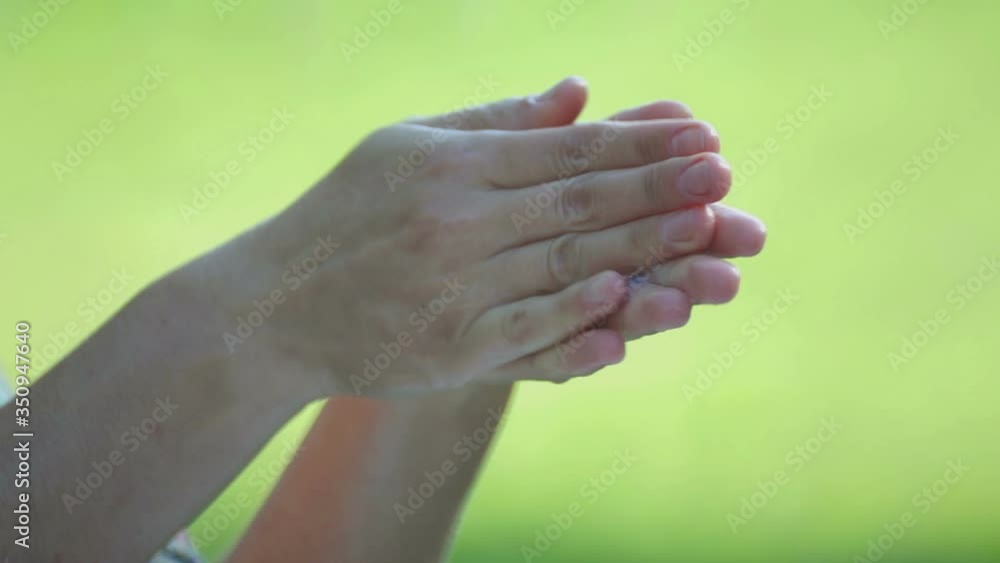 Woman washes hands with soap outdoors. Hands of a girl close-up while washing. Woman washes hands with soap outdoors. Hands of a girl close-up while washing.