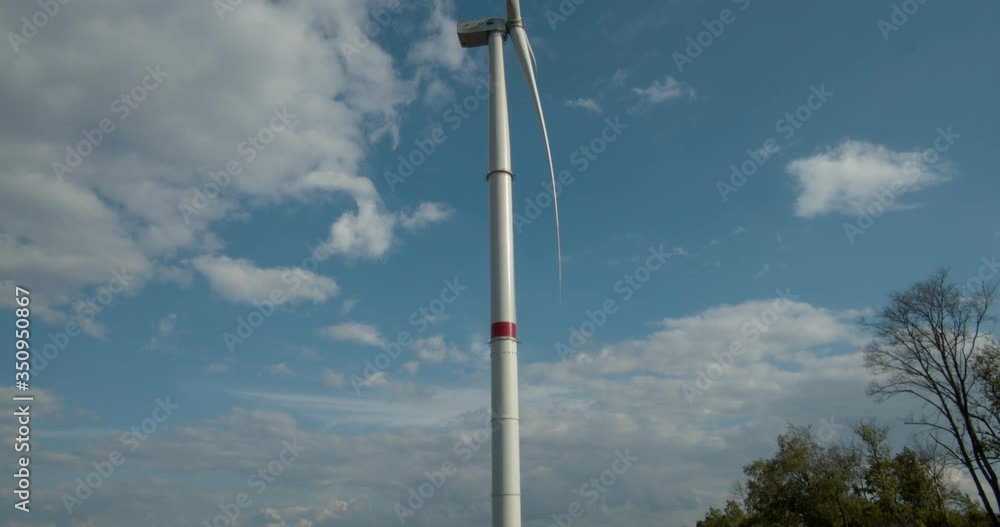 Wind generator on a background of blue sky and floating clouds. Green electricity. Wind generator on a background of blue sky and floating clouds. Green electricity.
