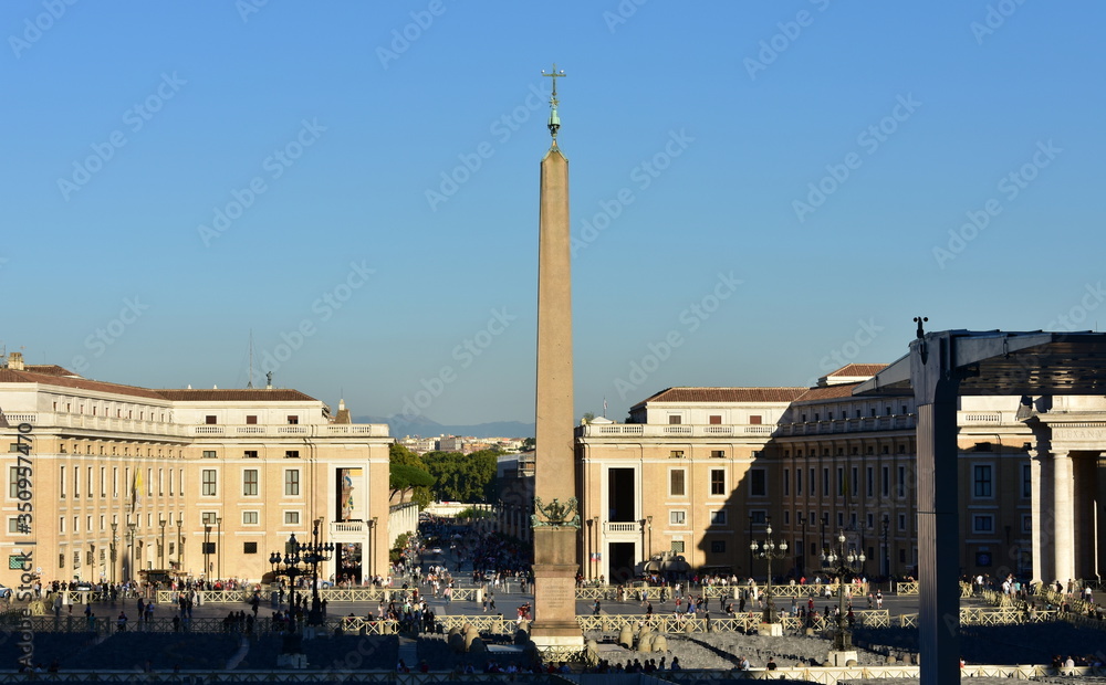 Vatican City, View of St. Peter’s Square with the egyptian Obelisk and blue sky at sunset. Rome, Italy.