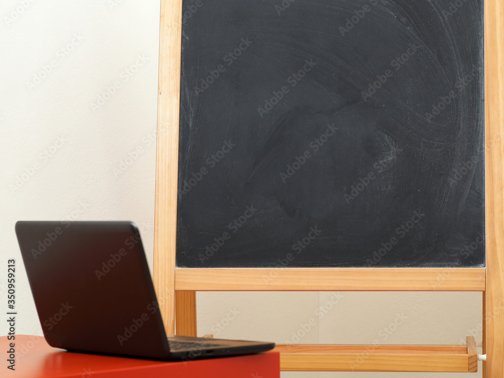 The concept of online education, a laptop and blackboard. Copy space. The concept of online education, a laptop and blackboard. Copy space.